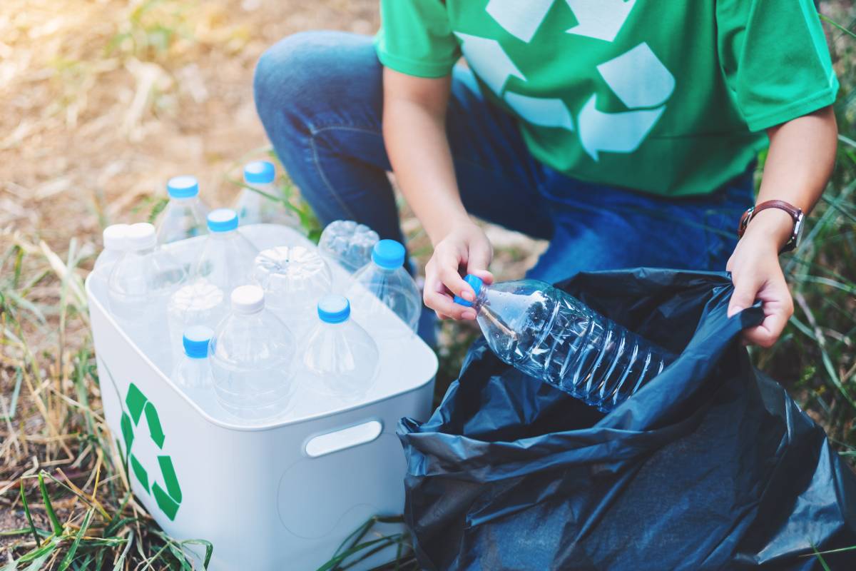 Woman recycling plastic bottles