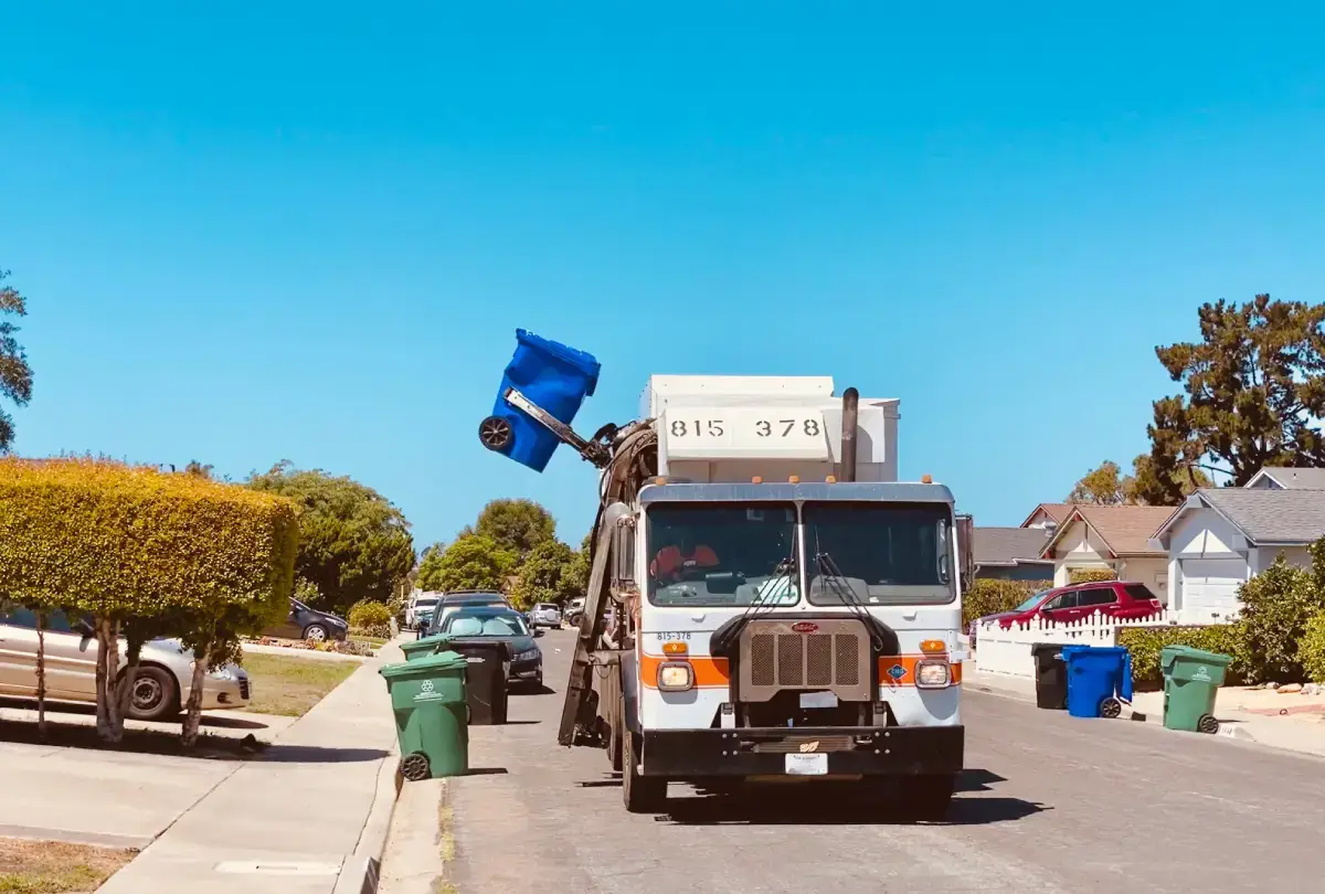 Recycling reality - recycling truck lifting up curbside waste bin