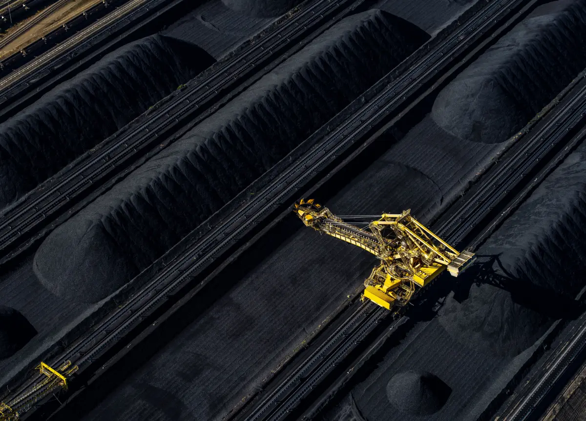 coal mining operation with a yellow crane