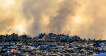 recycling and trash on fire in a landfill
